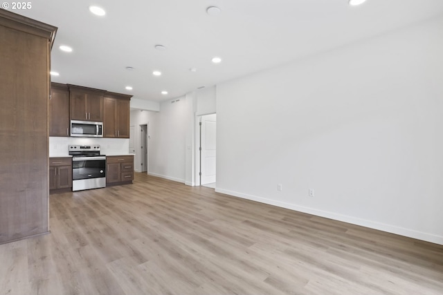1912 NW 18th Ave, Battle Ground, WA 98604 - kitchen with light countertops, recessed lighting, light wood-type flooring, stainless steel appliances, and baseboards