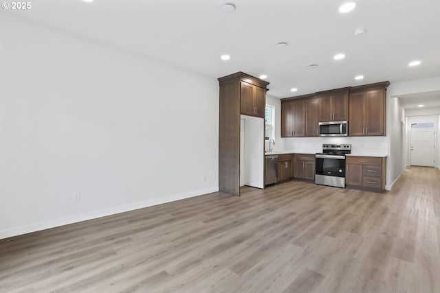 1912 NW 18th Ave, Battle Ground, WA 98604 - kitchen featuring light countertops, recessed lighting, stainless steel appliances, a sink, and light wood-style flooring