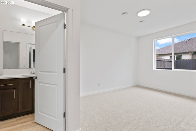 1912 NW 18th Ave, Battle Ground, WA 98604 - unfurnished room featuring a sink, baseboards, and light colored carpet