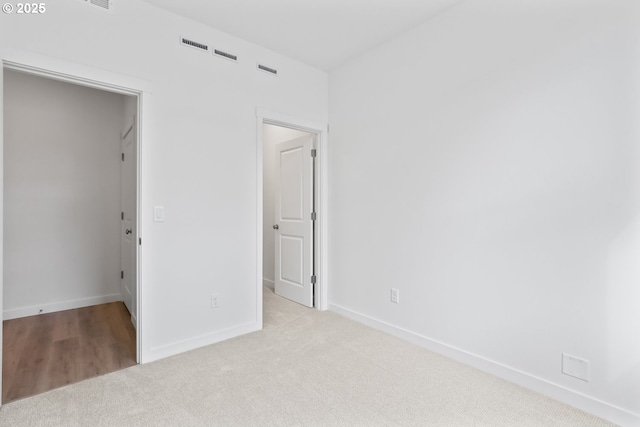 1912 NW 18th Ave, Battle Ground, WA 98604 - unfurnished bedroom featuring baseboards, carpet flooring, and a walk in closet