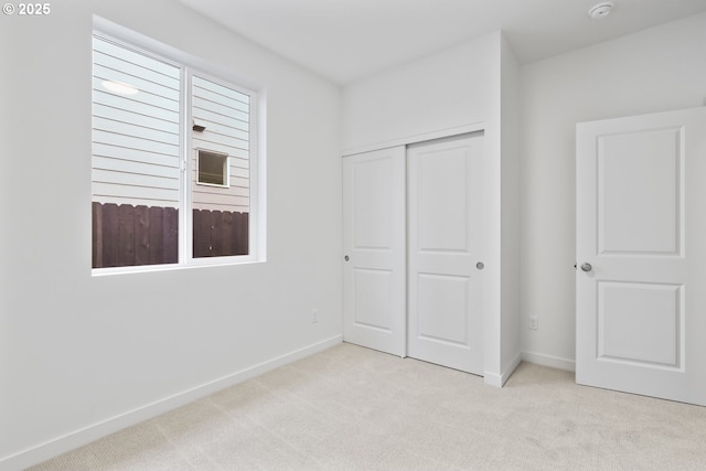 1912 NW 18th Ave, Battle Ground, WA 98604 - unfurnished bedroom featuring baseboards, a closet, and carpet