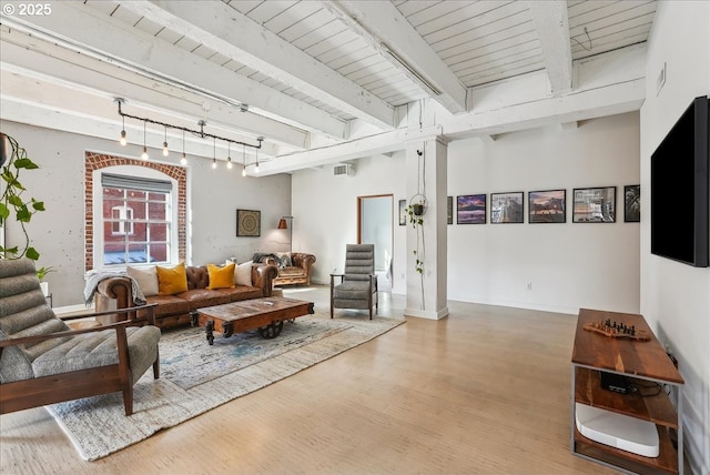 living room with beamed ceiling, wooden ceiling, wood finished floors, and rail lighting