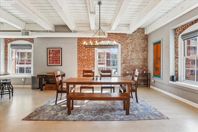 dining area with a wealth of natural light, beamed ceiling, and baseboards