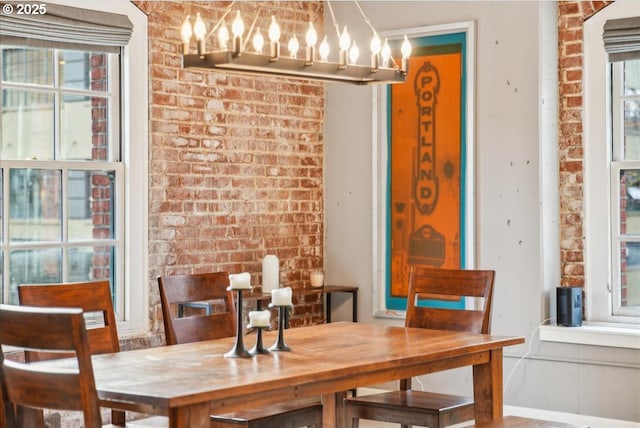 dining room with brick wall and baseboards