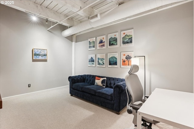 office area featuring carpet floors, rail lighting, visible vents, and baseboards