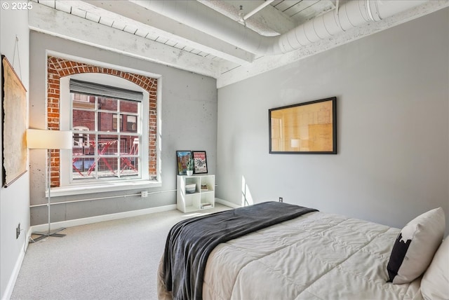 bedroom with carpet floors, baseboards, and beamed ceiling