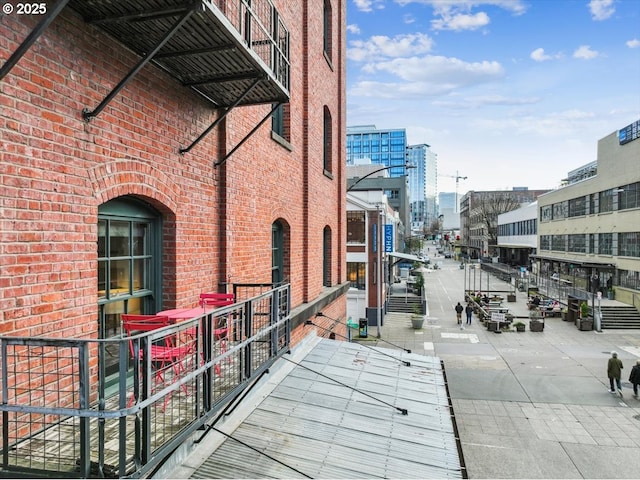 exterior space featuring a view of city and brick siding