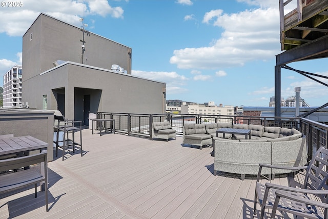 deck featuring an outdoor hangout area and a view of city