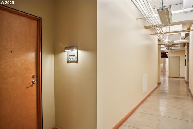 hallway with visible vents and baseboards