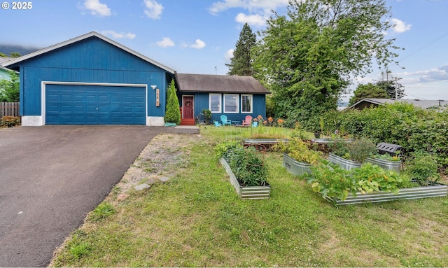 108 Watts Ave, Cascade Locks, OR 97014 - ranch-style house featuring a vegetable garden, asphalt driveway, a garage, and a front lawn