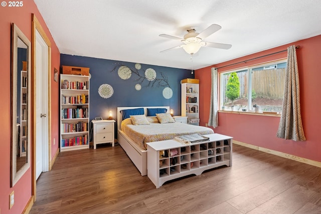 108 Watts Ave, Cascade Locks, OR 97014 - bedroom featuring wood finished floors, an accent wall, and a ceiling fan