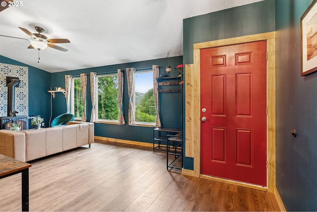 108 Watts Ave, Cascade Locks, OR 97014 - foyer entrance with a ceiling fan, a wood stove, and wood finished floors