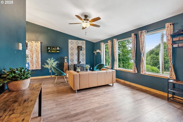 108 Watts Ave, Cascade Locks, OR 97014 - living room featuring a wood stove, wood finished floors, a ceiling fan, and lofted ceiling