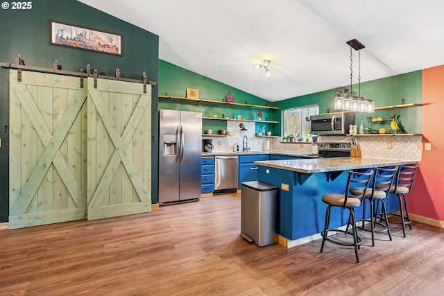 108 Watts Ave, Cascade Locks, OR 97014 - kitchen with open shelves, appliances with stainless steel finishes, lofted ceiling, decorative backsplash, and light wood-style flooring