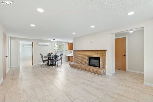 2065 Providence St, Eugene, OR 97401 - living area with a wall mounted air conditioner, recessed lighting, and a fireplace