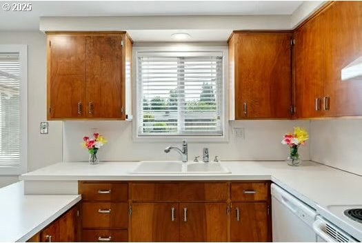 2065 Providence St, Eugene, OR 97401 - kitchen with white dishwasher, light countertops, and brown cabinetry