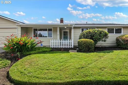 2065 Providence St, Eugene, OR 97401 - view of front of home with an attached garage, a front lawn, and a chimney