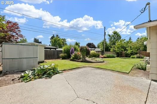 2065 Providence St, Eugene, OR 97401 - fenced backyard with a patio and a storage unit