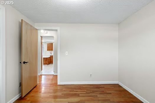 2065 Providence St, Eugene, OR 97401 - unfurnished room with wood finished floors and a textured ceiling