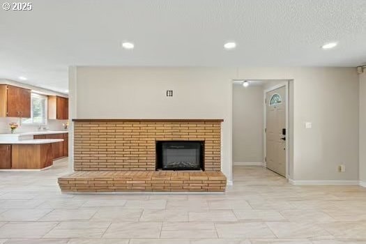 2065 Providence St, Eugene, OR 97401 - unfurnished living room featuring recessed lighting and a brick fireplace