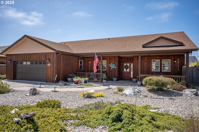 ranch-style home with concrete driveway, a garage, board and batten siding, and covered porch