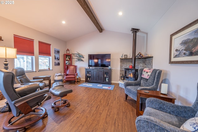 living area with wood finished floors, lofted ceiling with beams, a wood stove, and baseboards