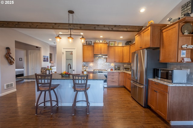 kitchen featuring visible vents, dark wood-style flooring, stainless steel appliances, and under cabinet range hood
