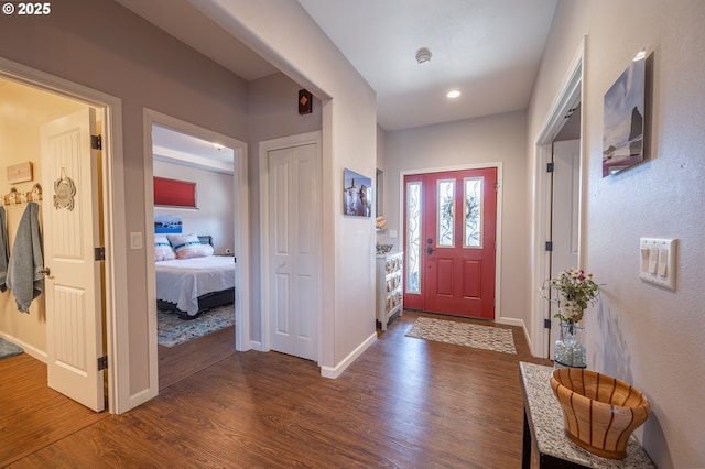 entryway with wood finished floors, recessed lighting, and baseboards
