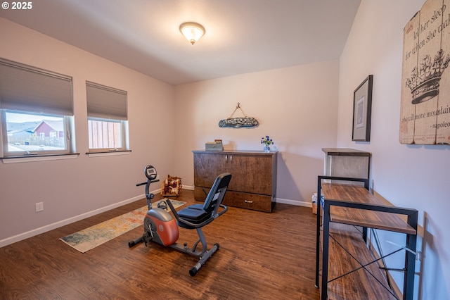 exercise room with wood finished floors and baseboards
