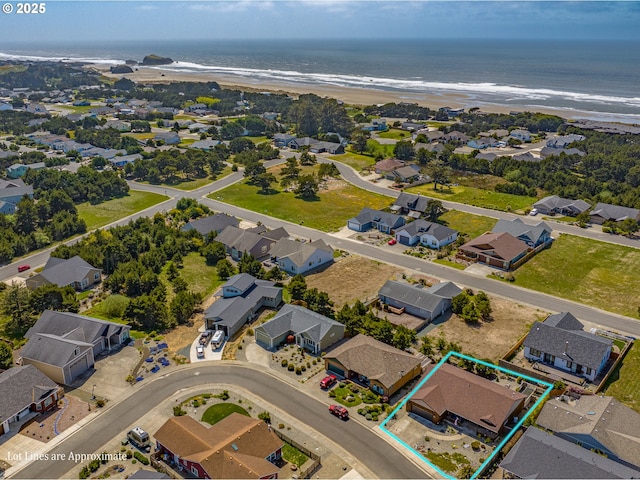 birds eye view of property featuring a beach view, a water view, and a residential view