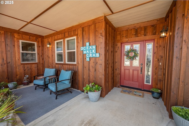 entrance to property with covered porch and board and batten siding