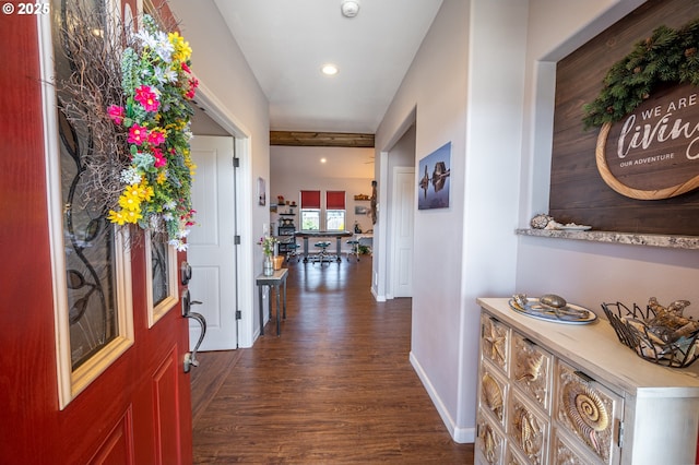 hallway featuring baseboards and dark wood-style flooring