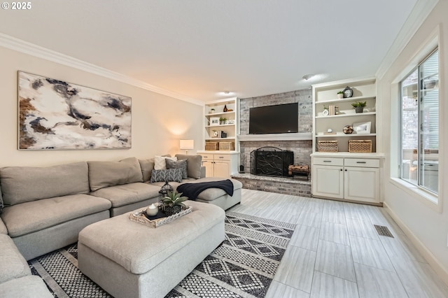 living area with a fireplace, baseboards, crown molding, and built in features