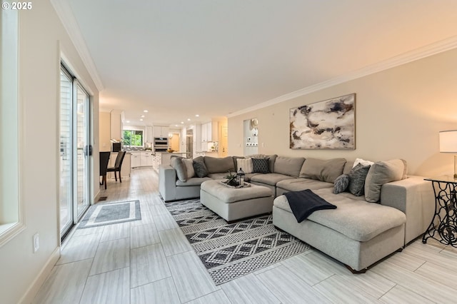 living room with ornamental molding, recessed lighting, wood tiled floors, and baseboards