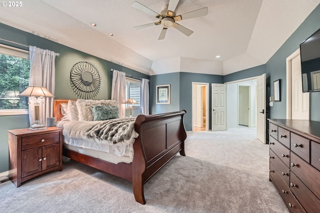 bedroom featuring multiple windows, light carpet, lofted ceiling, baseboards, and ceiling fan