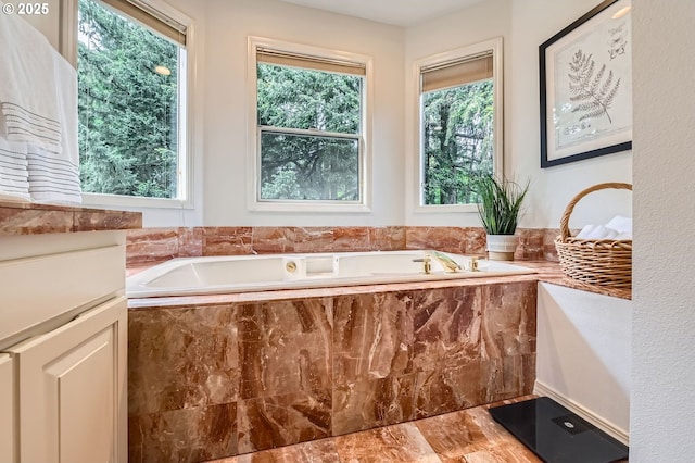 full bath with a garden tub and marble look tiles