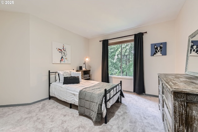 bedroom with light carpet and baseboards