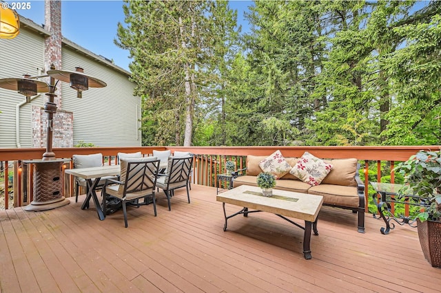 wooden deck with an outdoor living space and outdoor dining area