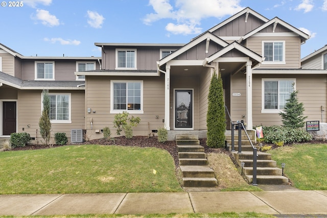 view of front of home with board and batten siding, a front yard, and crawl space