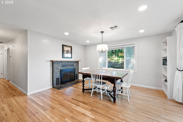 3370 Alder St, Eugene, OR 97405 - dining area with light wood-type flooring, recessed lighting, and a stone fireplace