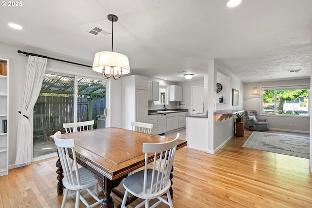 3370 Alder St, Eugene, OR 97405 - dining area featuring light wood finished floors, a chandelier, and recessed lighting