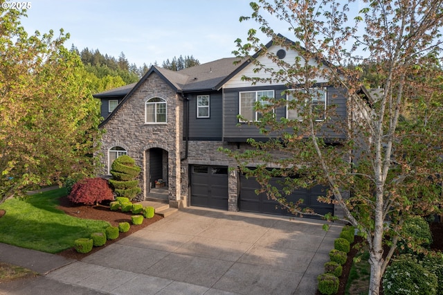 14956 SE Pebble Beach Dr, Happy Valley, OR 97086 - view of front of house with stone siding, concrete driveway, and a garage