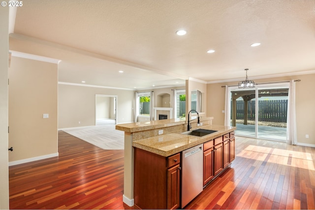 14956 SE Pebble Beach Dr, Happy Valley, OR 97086 - kitchen featuring stainless steel dishwasher, dark wood finished floors, tile counters, a glass covered fireplace, and crown molding