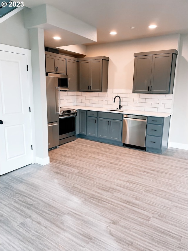 304 N Bridgeton Rd, Portland, OR 97217 - kitchen with stainless steel appliances, light countertops, backsplash, light wood-type flooring, and recessed lighting