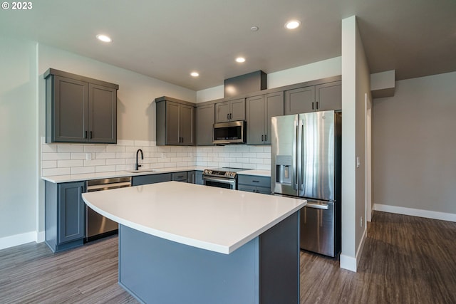 304 N Bridgeton Rd, Portland, OR 97217 - kitchen featuring stainless steel appliances, wood finished floors, decorative backsplash, and recessed lighting