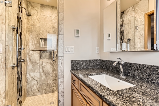 full bathroom featuring a stall shower and vanity