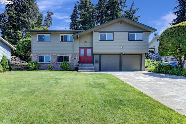 703 NW 94th St, Vancouver, WA 98665 - bi-level home with an attached garage, concrete driveway, a front yard, and brick siding
