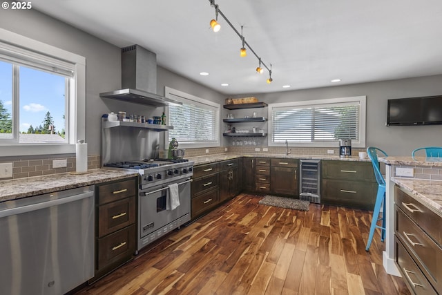 703 NW 94th St, Vancouver, WA 98665 - kitchen with appliances with stainless steel finishes, wine cooler, wall chimney exhaust hood, open shelves, and dark brown cabinets