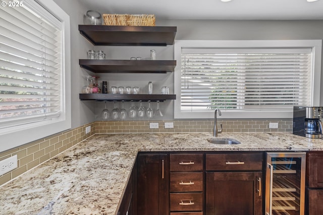 703 NW 94th St, Vancouver, WA 98665 - kitchen featuring beverage cooler, tasteful backsplash, dark brown cabinetry, light stone counters, and open shelves
