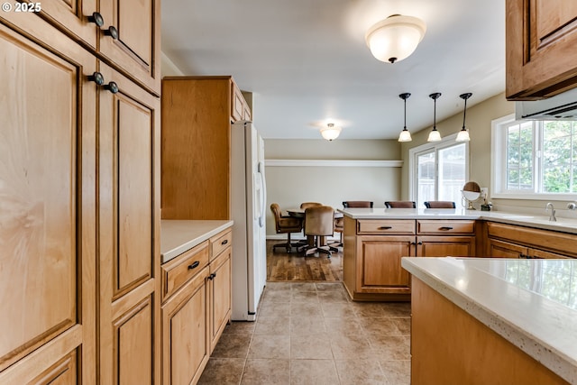 488 Pinto Way, Eugene, OR 97401 - kitchen featuring a sink, white fridge with ice dispenser, pendant lighting, and light countertops